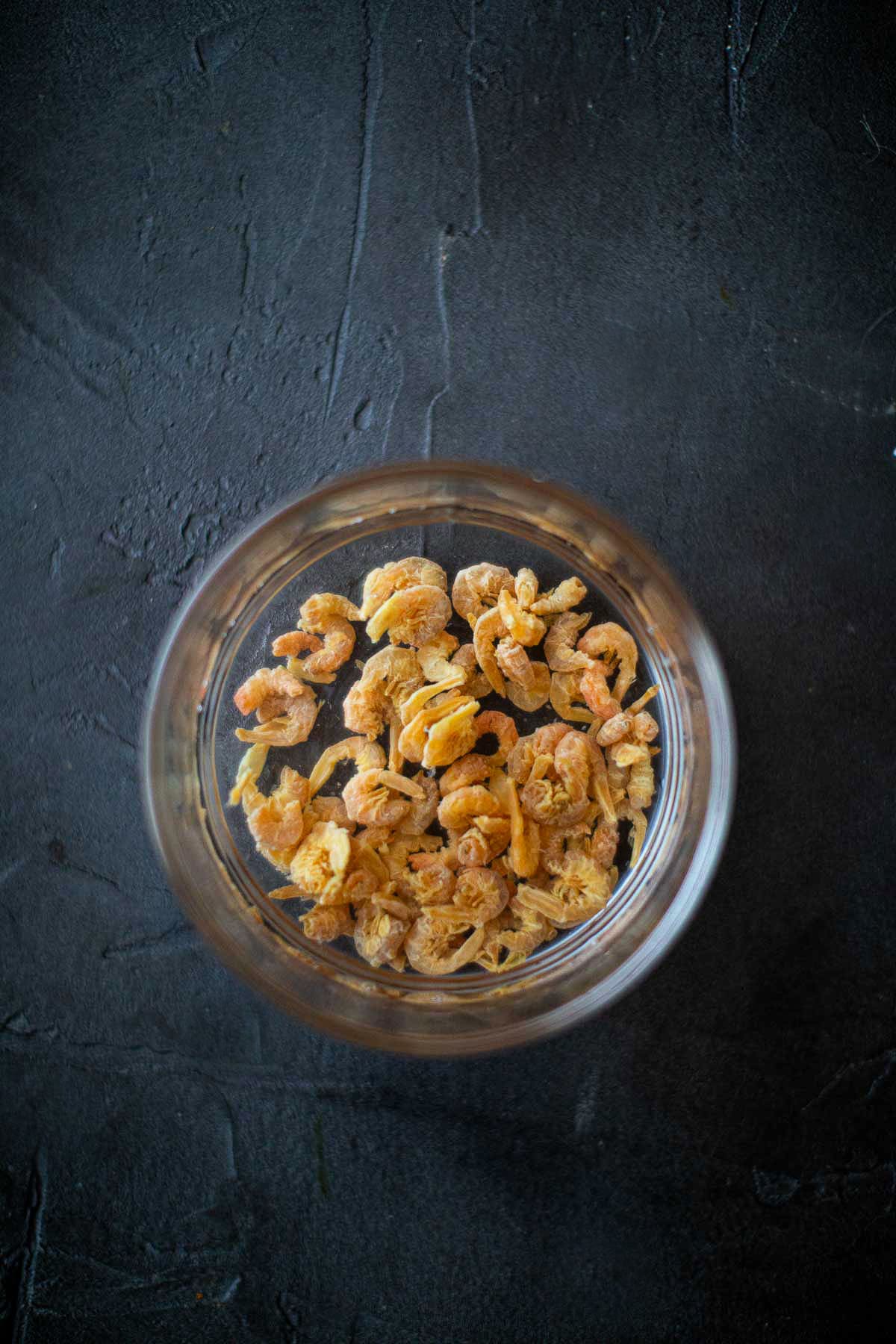 Soaked dried shrimp in a bowl for Yum Woon Sen salad.