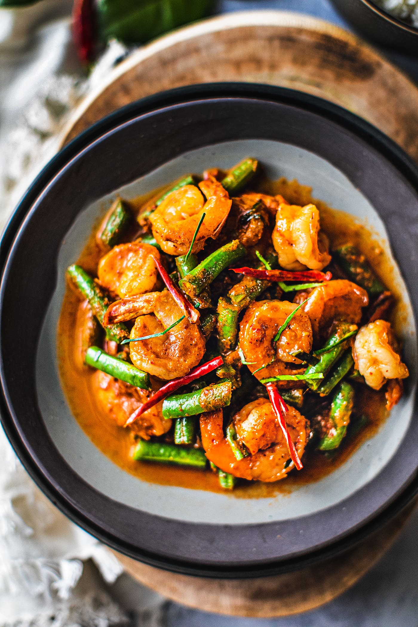 stir fried green beans and shrimp on a plate.