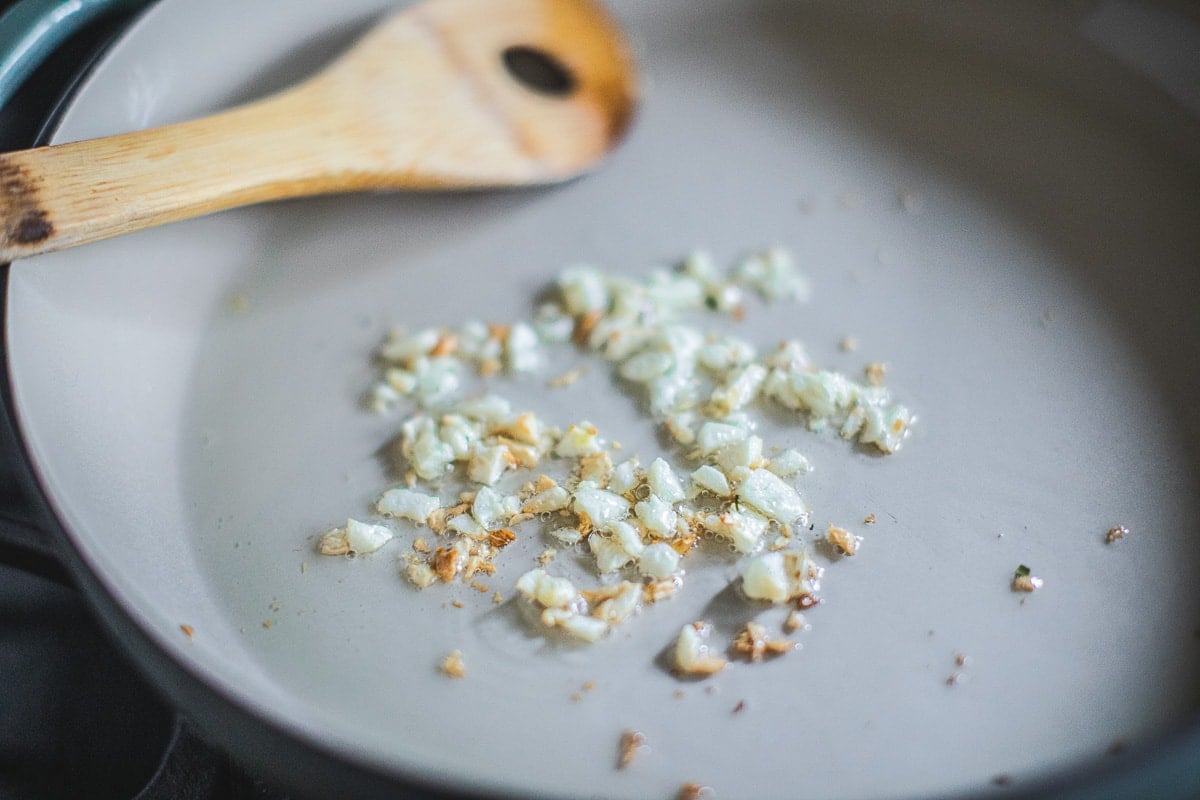 frying garlic in a pan for prik king curry.