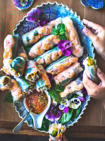 Vietnamese spring rolls on a blue platter.