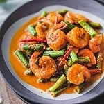 Shrimp curry with green beans on a plate.