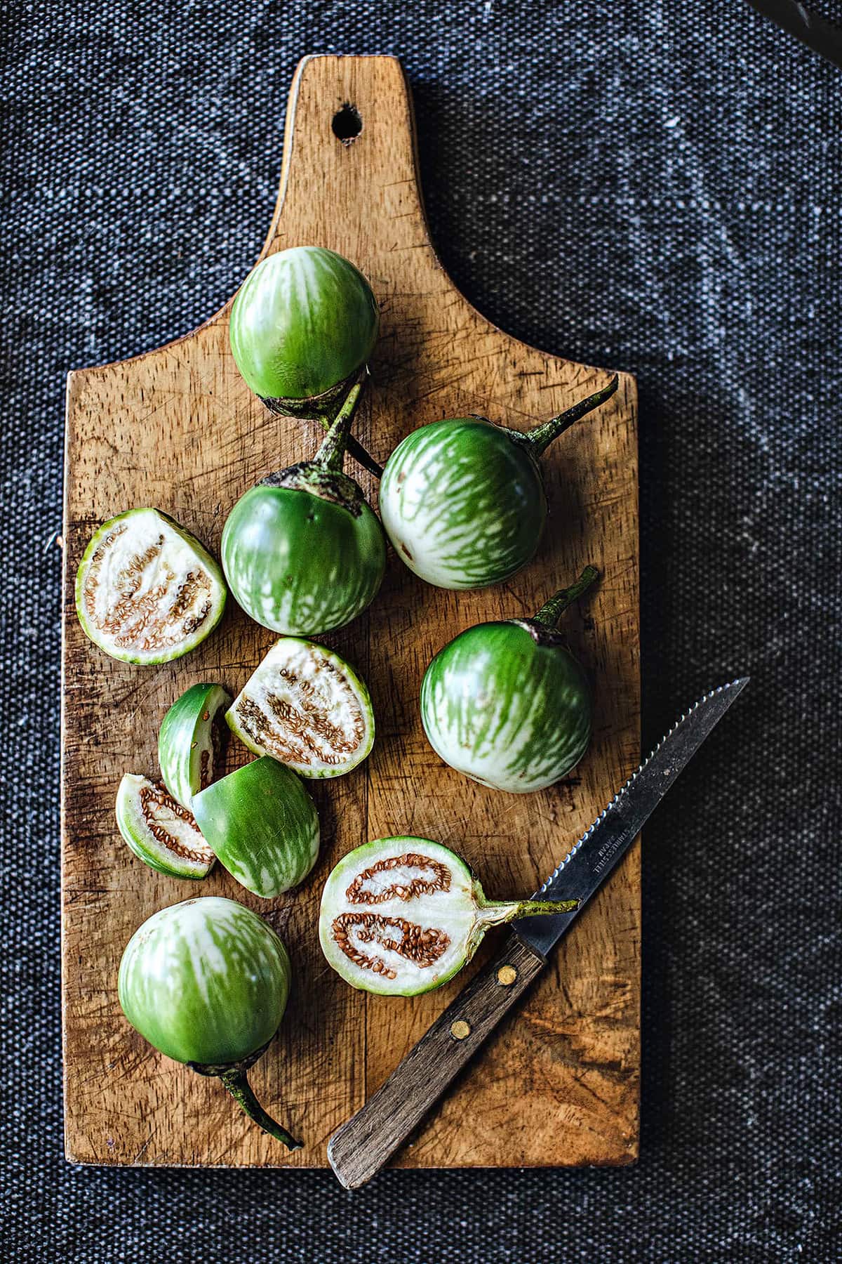 Thai eggplants on a cutting board. 