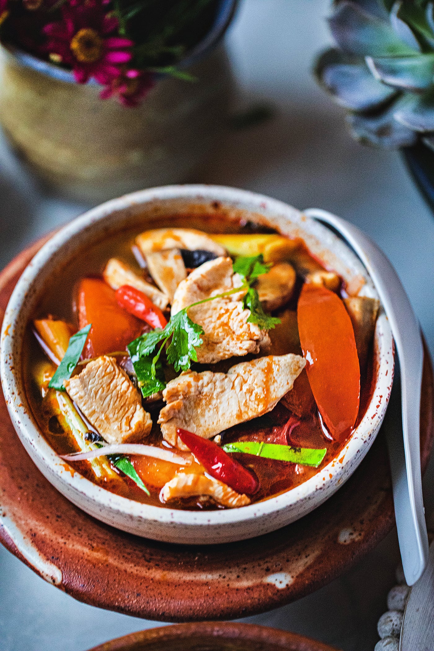 Chicken Tom Yum soup in a small bowl.