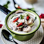 Thai tom kha gai in a bowl on the table.