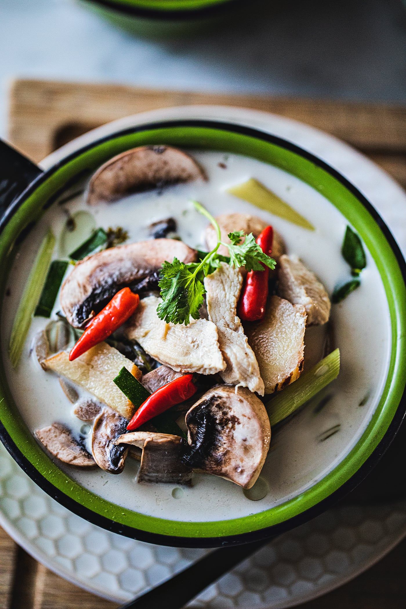 Tom Kha gai is a very well known Thai soup made by using chicken, coconut milk, herbs fish sauce, and lime juice. It is a creamy light soup that is not only delicious but also full of fresh herbs that will keep you healthy all winter long.  #thaicoconutsoup #thaichickencoconutsoup #tomkhagai #thaicoconutchickensoup #easythaisoup