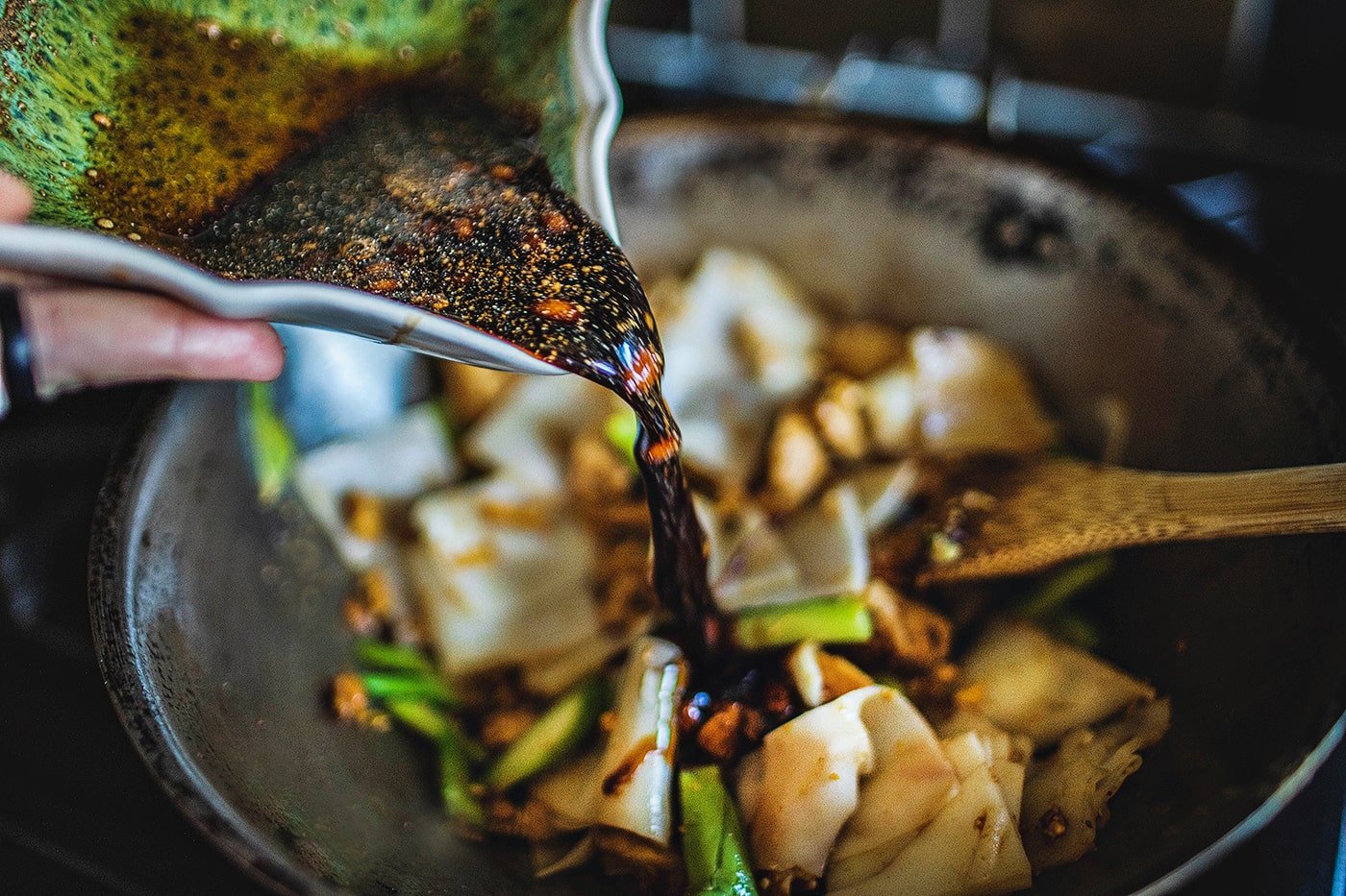 Sauce pouring over pad see ew recipe.