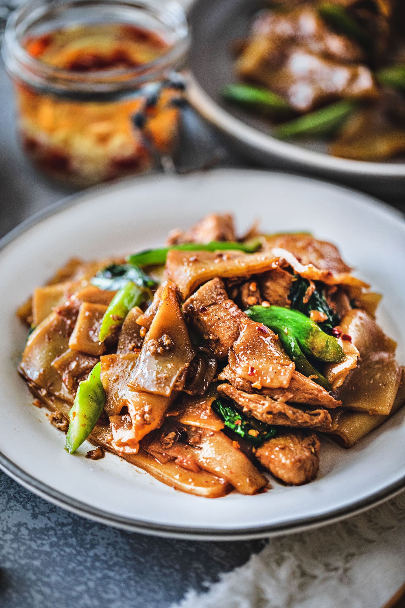 Pad See Ew is one of the most delicious Thai stir fry dishes! It uses wide rice noodles, garlic, eggs, sauces, and Chinese broccoli. This popular street food has a silky and savory flavor from the use of Thai sauces, making this Pad See Ew recipe delightfully memorable. #padseeew #thaifood #padseeewrecipe #senyai 