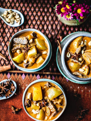 Thai beef massaman curry on 3 bowls.