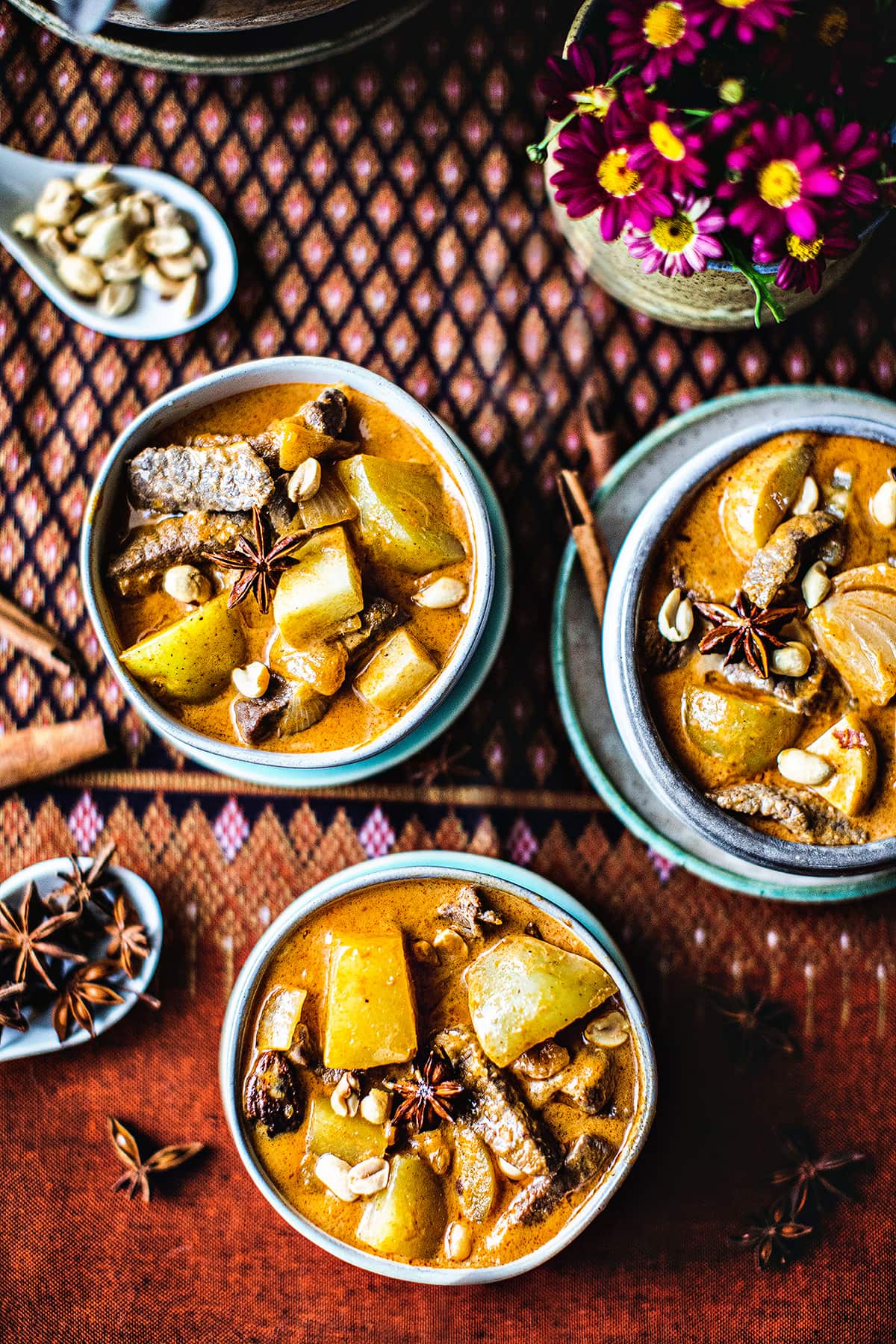 Massaman curry in 3 small bowls on the table. 