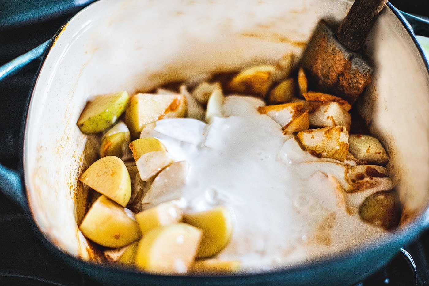 Massaman curry in a soup pot with potatoes and coconut milk.