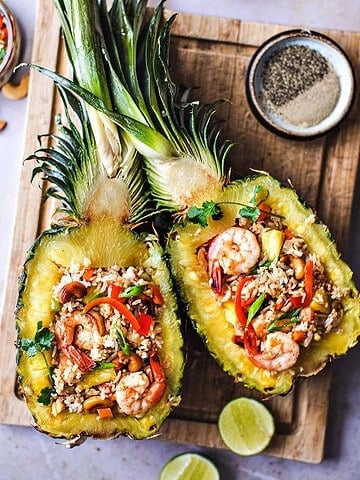 Thai pineapple fried rice on pineapple boats.