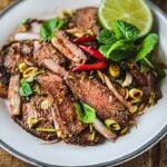 thai beef salad with sliced beef on a plate