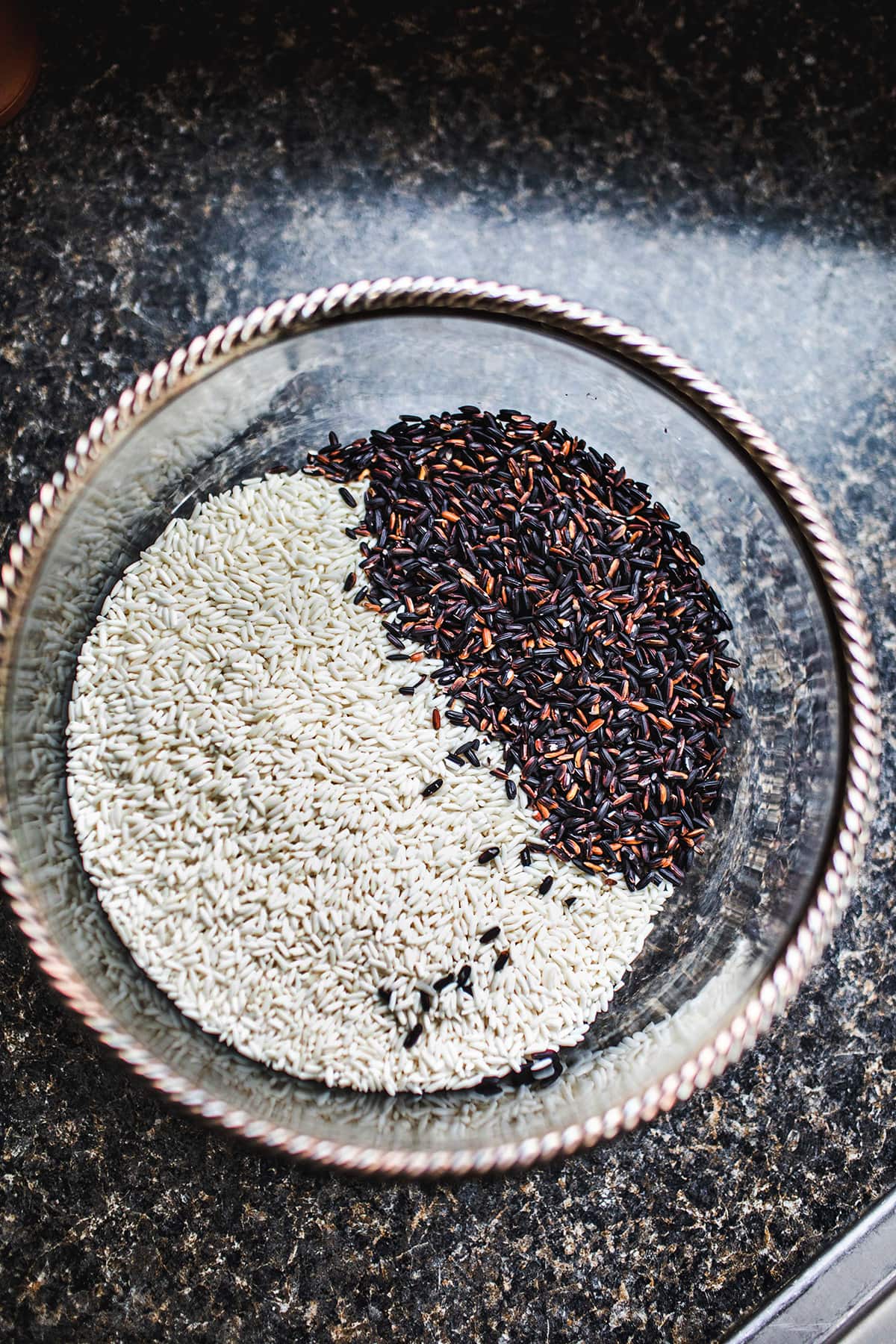 white and black sticky rice in a glass bowl
