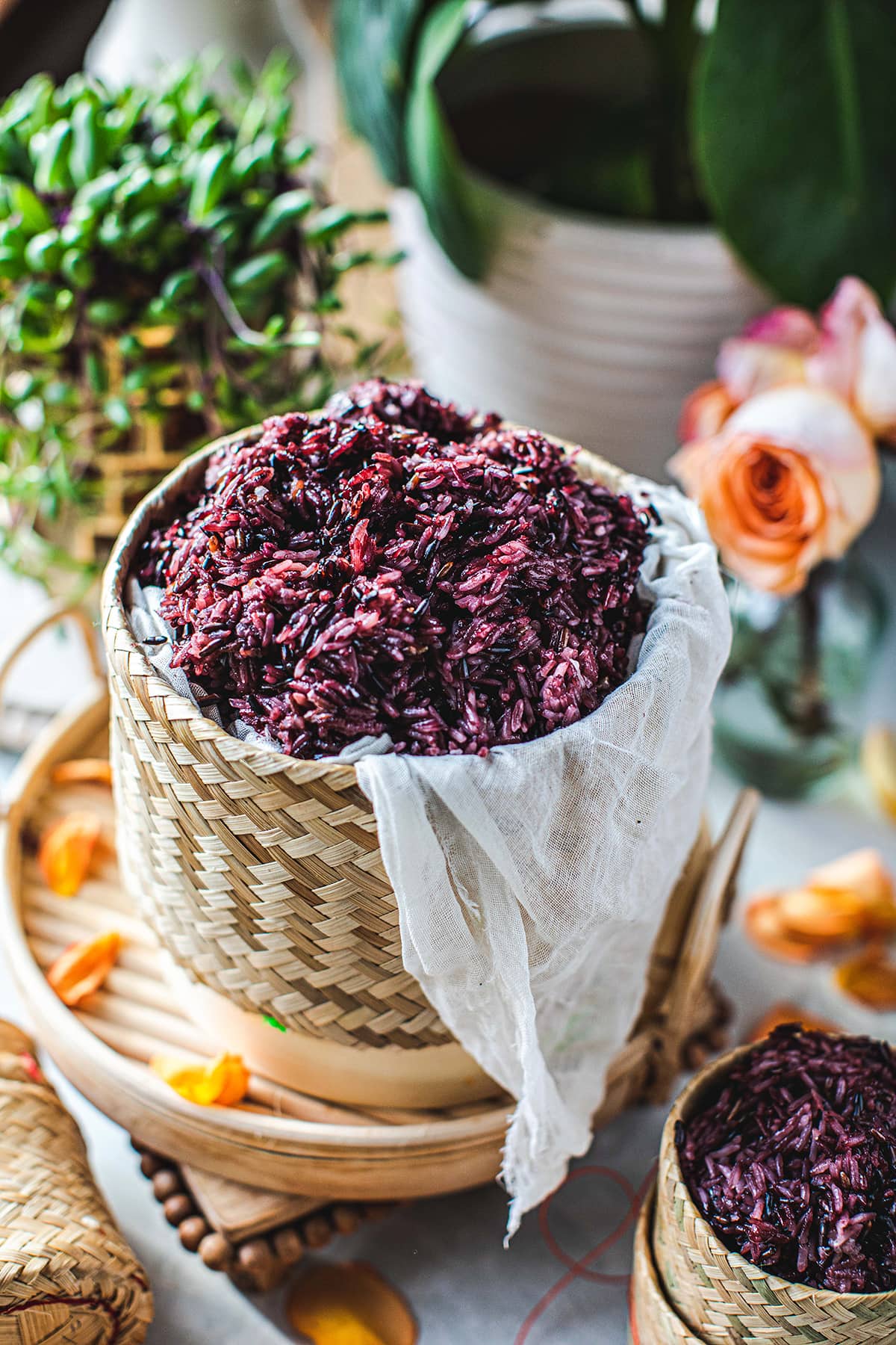 cooked purple rice in a bamboo basket on a table