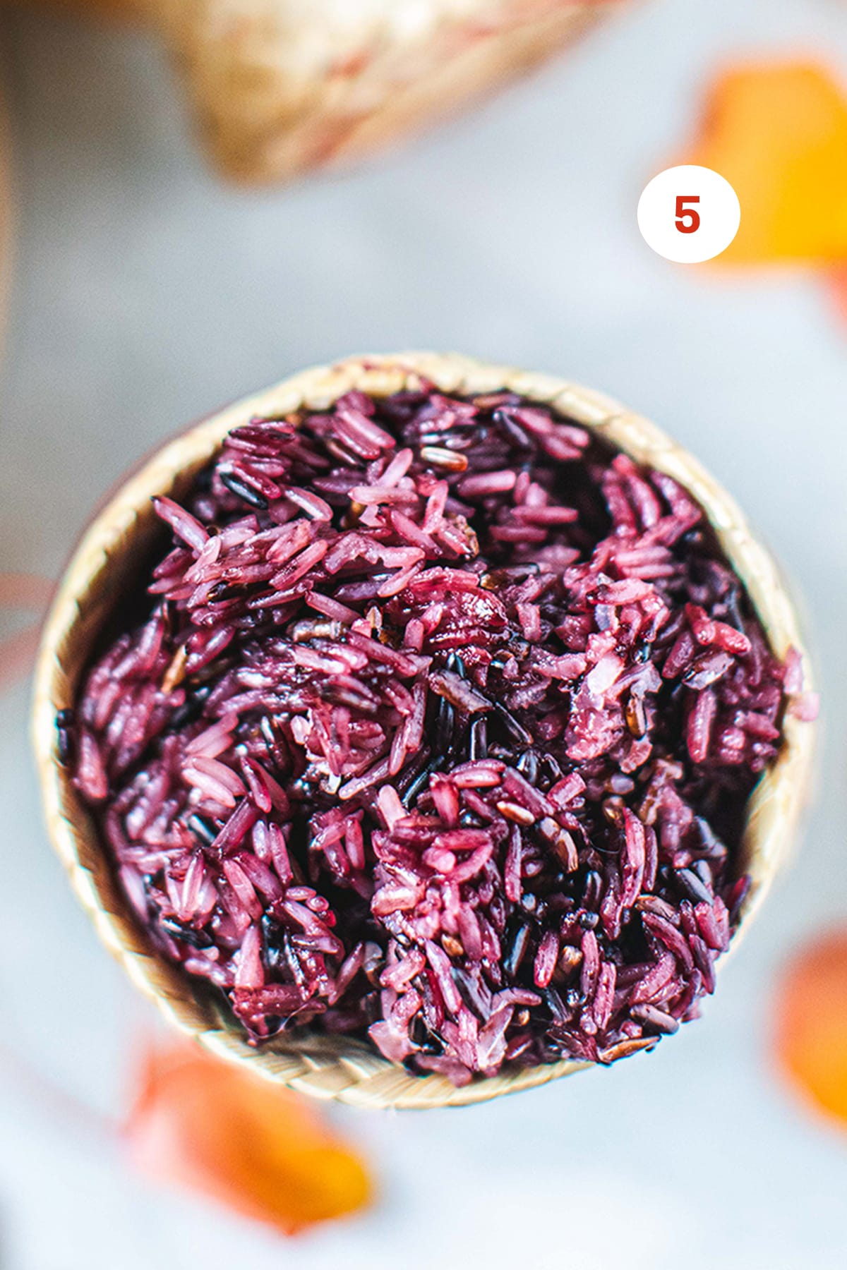 cooked purple rice in a bamboo basket