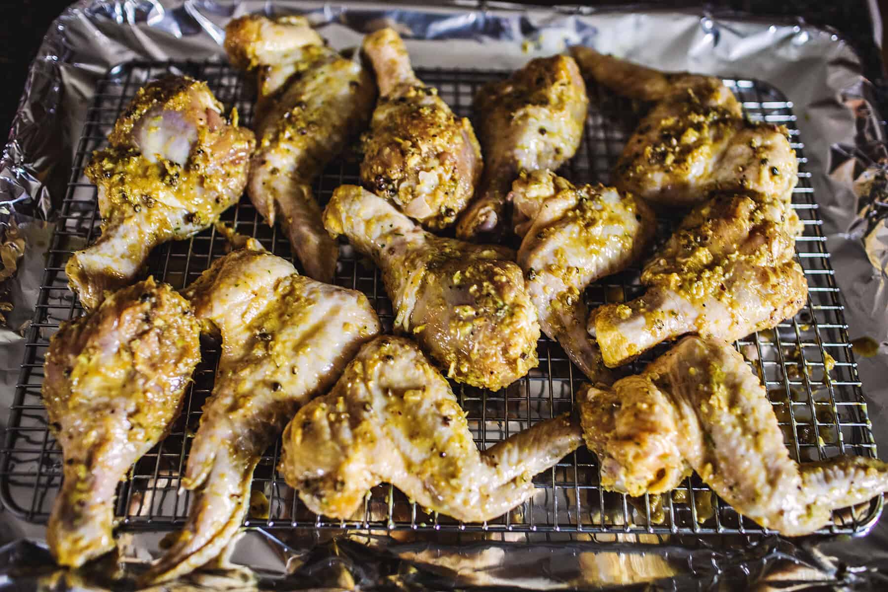 Gai yang chicken wings on baking rack.