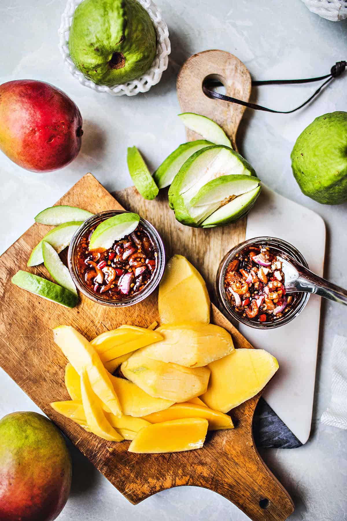 Mango dipping sauce in small bowls with mango slices. 