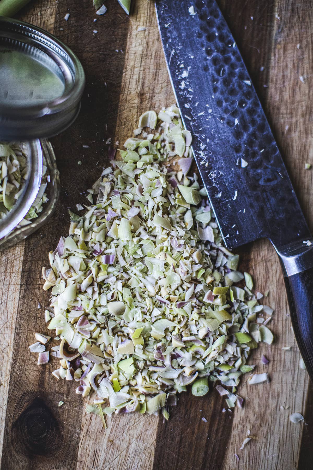 minced lemongrass next to knife on a cutting board