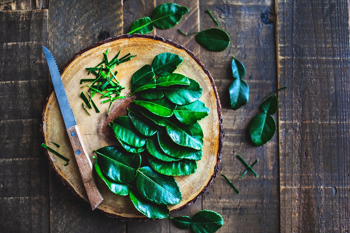 kaffir lime leaves on a cutting board