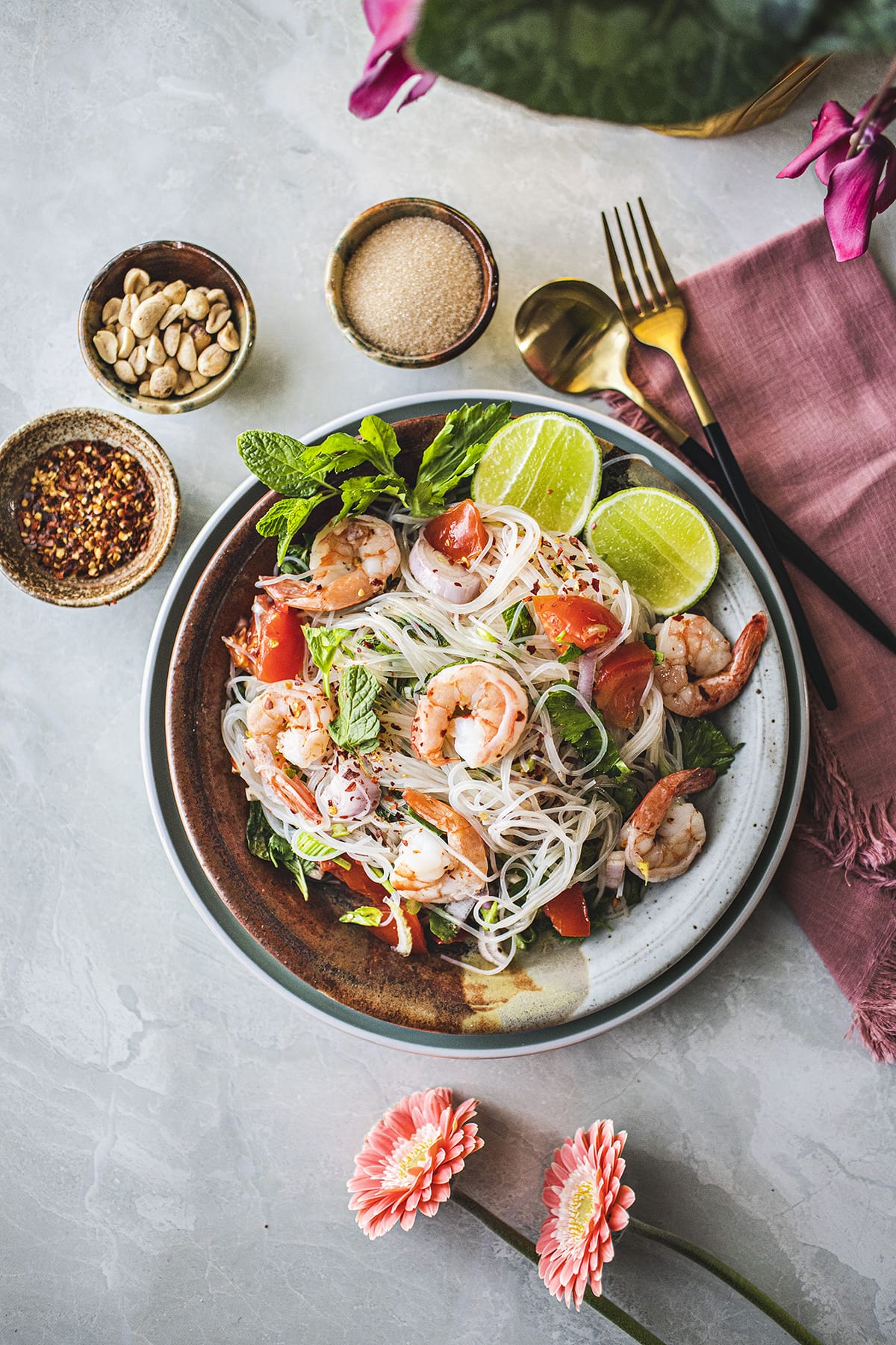 Styled glass noodles salad on a plate with garnishes.