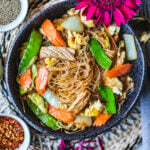 Noodles with vegetables in a black bowl