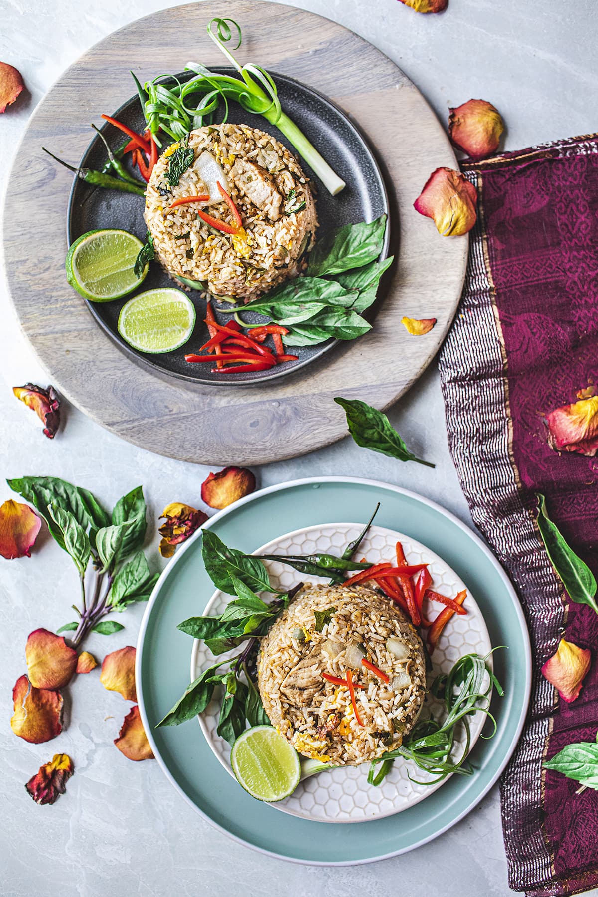 2 platters of fried rice with garnishes on the side