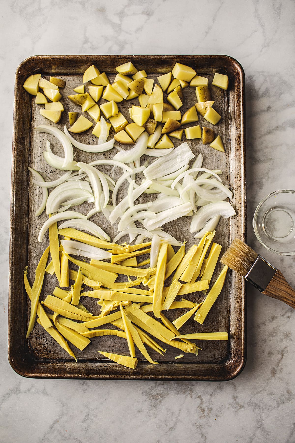 bamboo shoots, potatoes and onions in baking pan