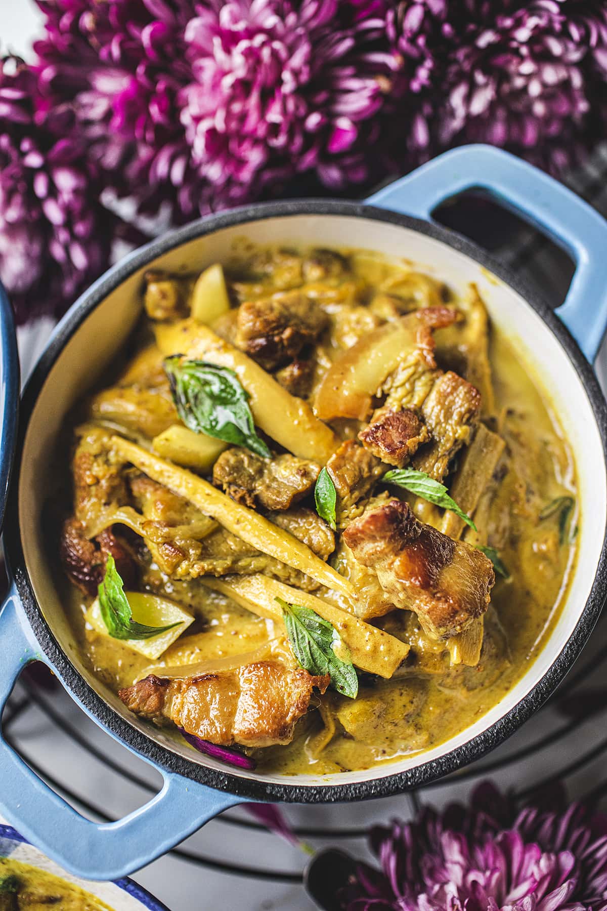 Yellow curry in a blue dutch oven on the table
