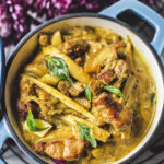 yellow curry in a blue dutch oven on a table