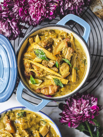 yellow curry in a blue dutch oven on a table