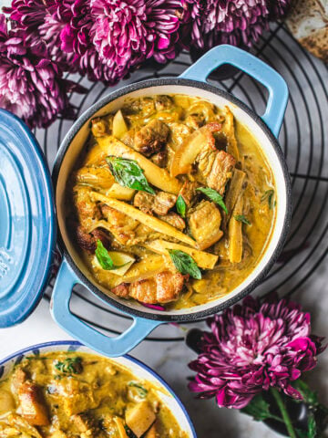 yellow curry in a blue dutch oven on a table