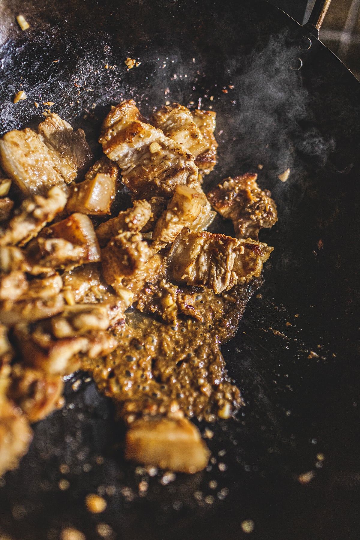 Pad Prik King curry with pork belly in a wok.