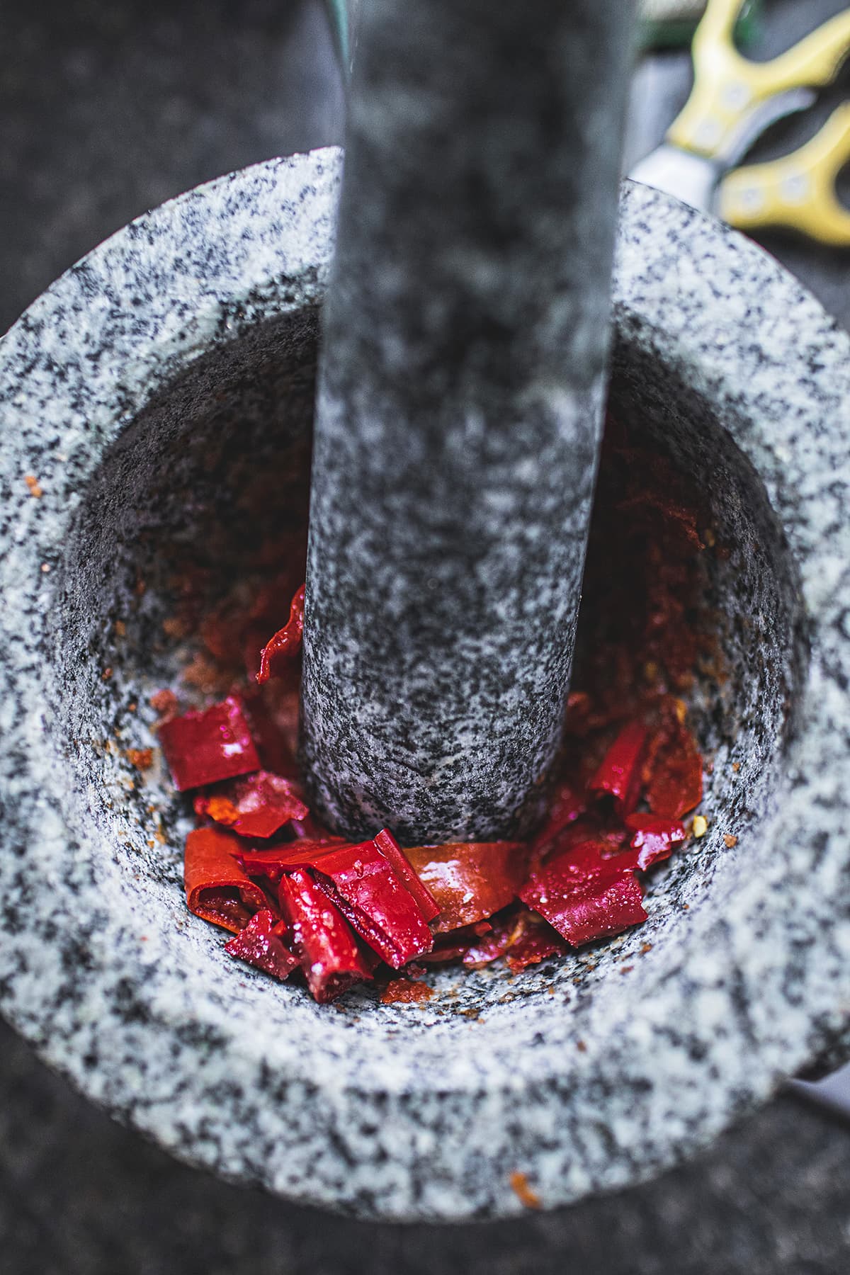 Chilis pounding in a mortar.