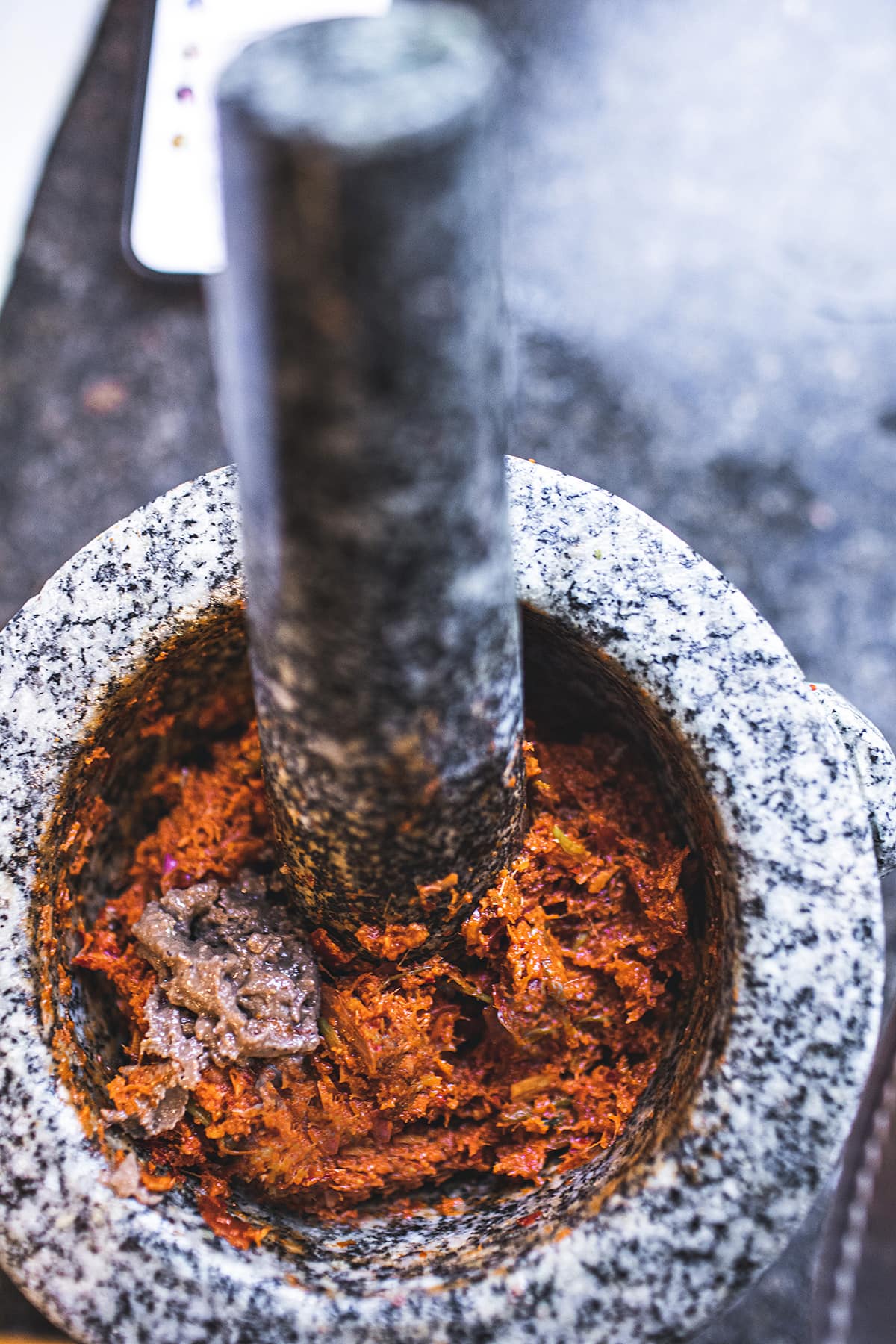 Prik Khing Thai curry paste in a mortar and pestle with shrimp paste.