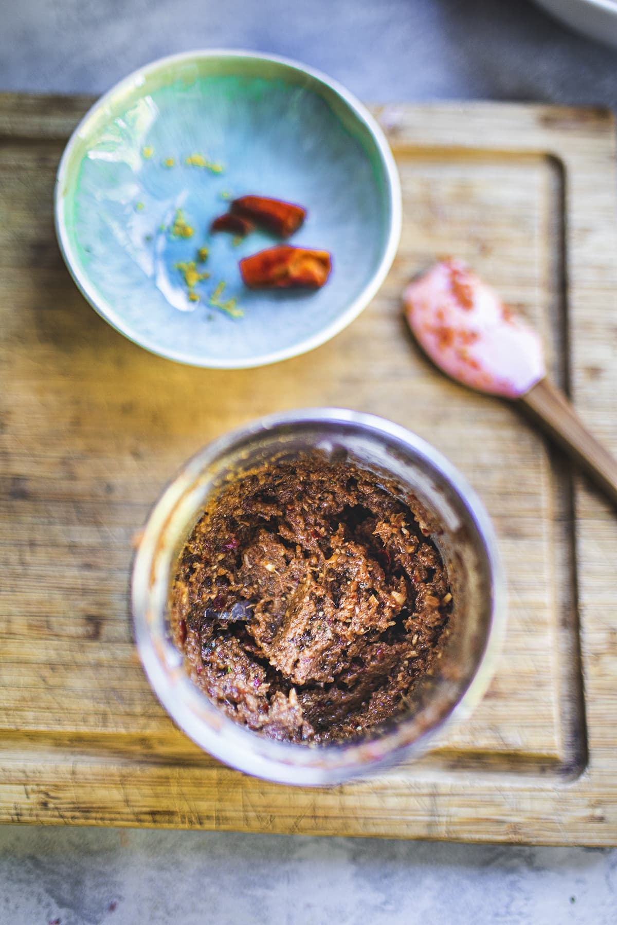 Prik Khing Thai curry paste in a spice grinder on a cutting board.