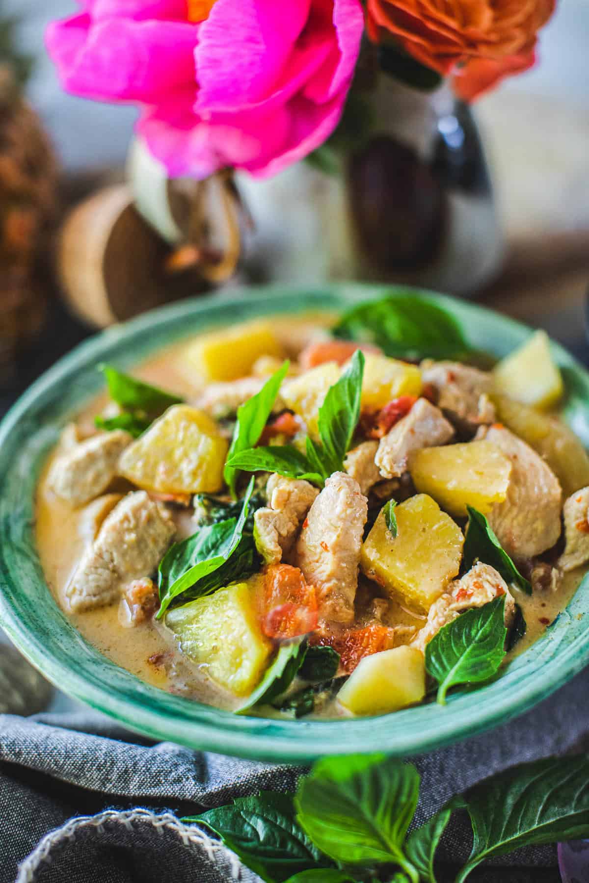 pineapple curry with chicken in a green bowl