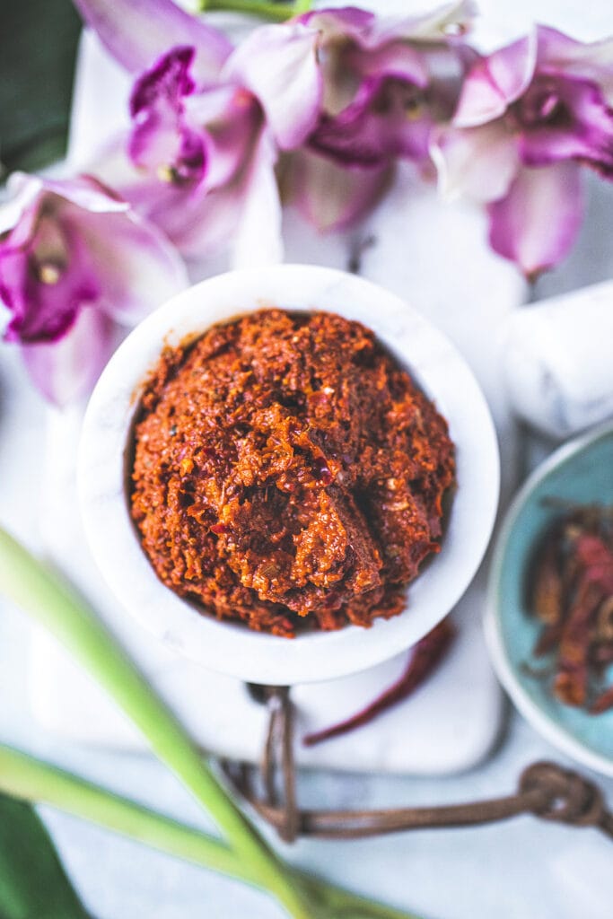 Thai red curry paste in a white bowl.