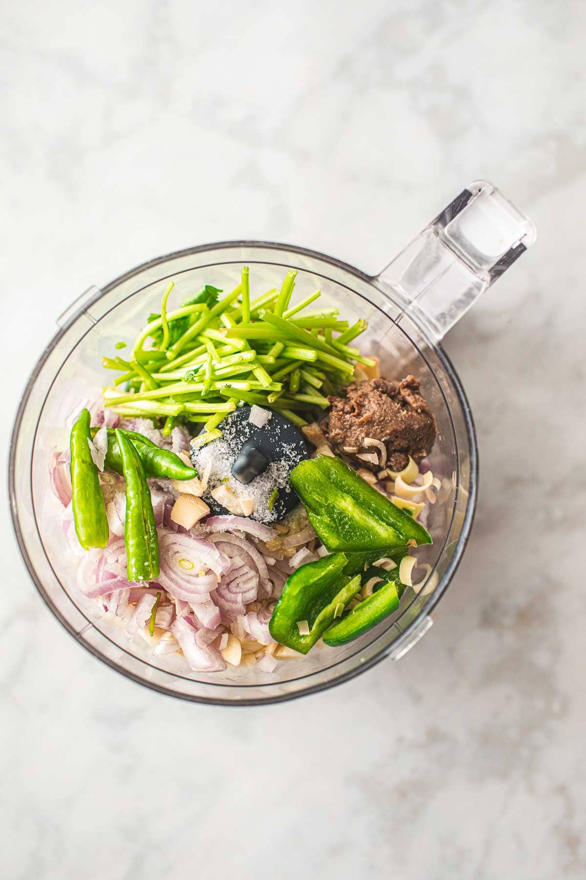 Thai  green curry paste ingredients in a food processor.