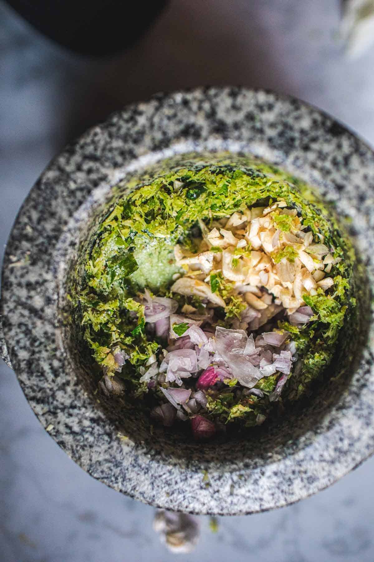 Fresh herbs in a mortar.