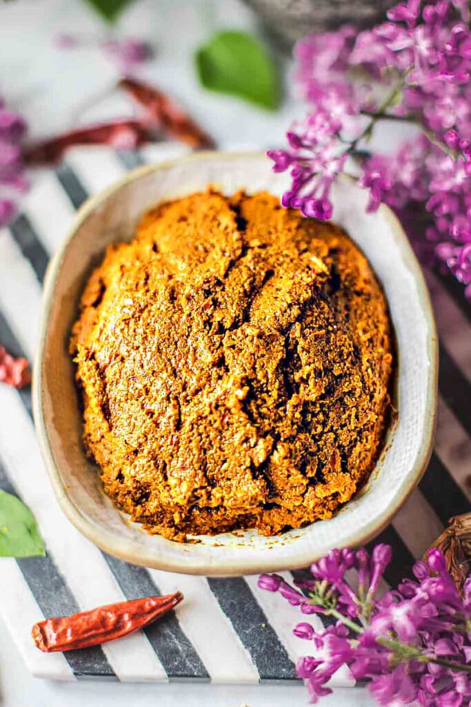 Yellow curry paste in a white bowl on the table. 