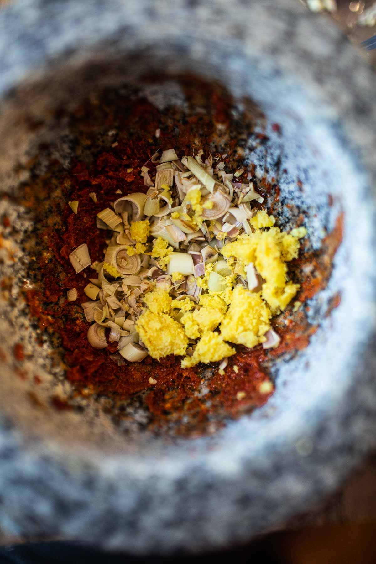 curry paste ingredients in mortar and pestle