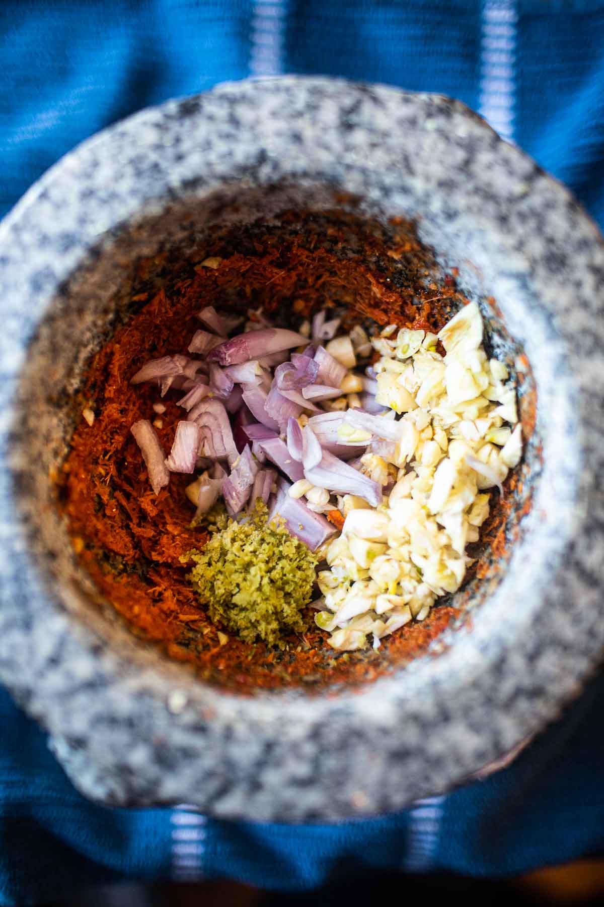 curry paste ingredients in mortar and pestle