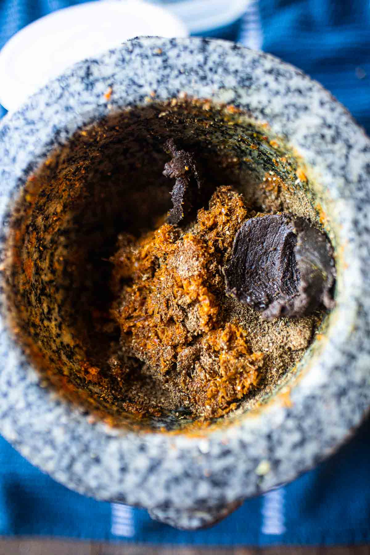 curry paste ingredients in mortar and pestle