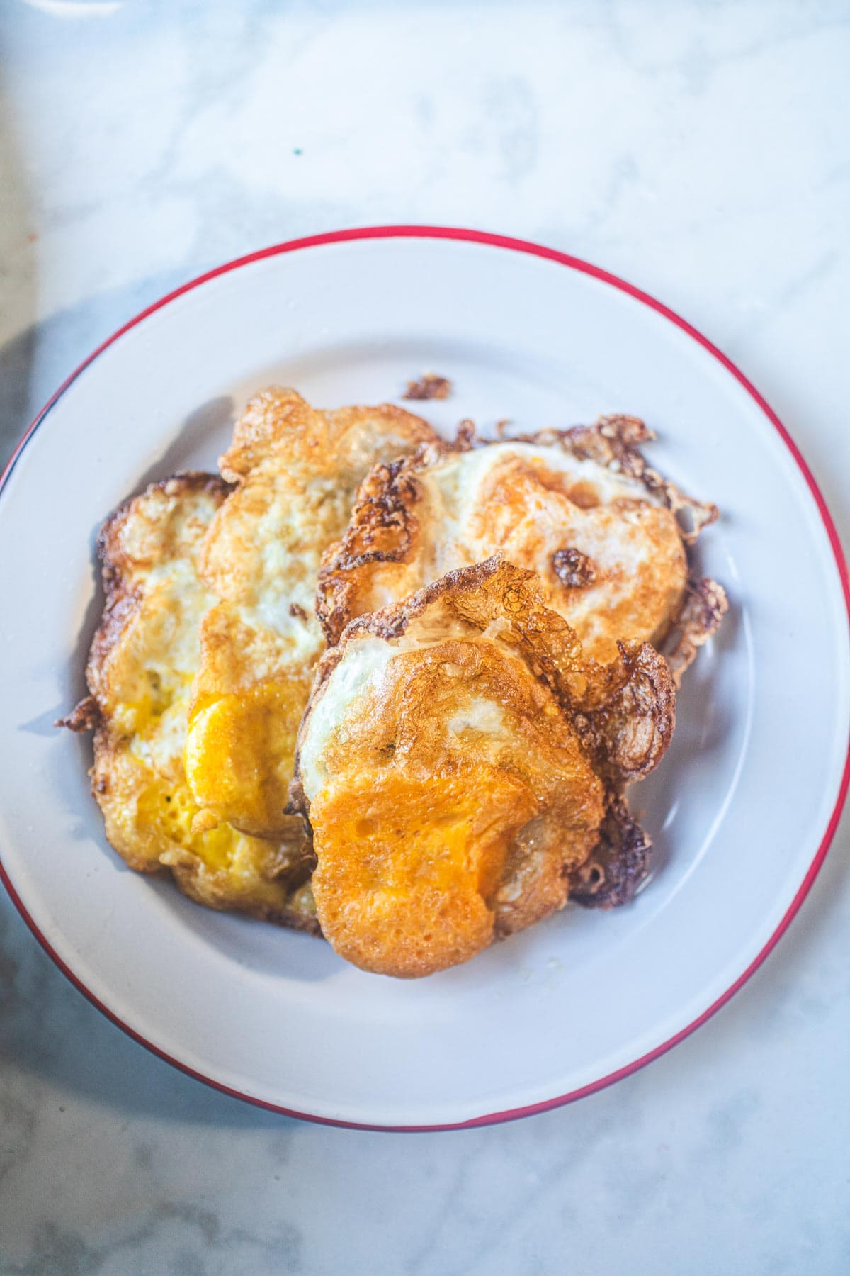 3 crispy fried eggs in a plate
