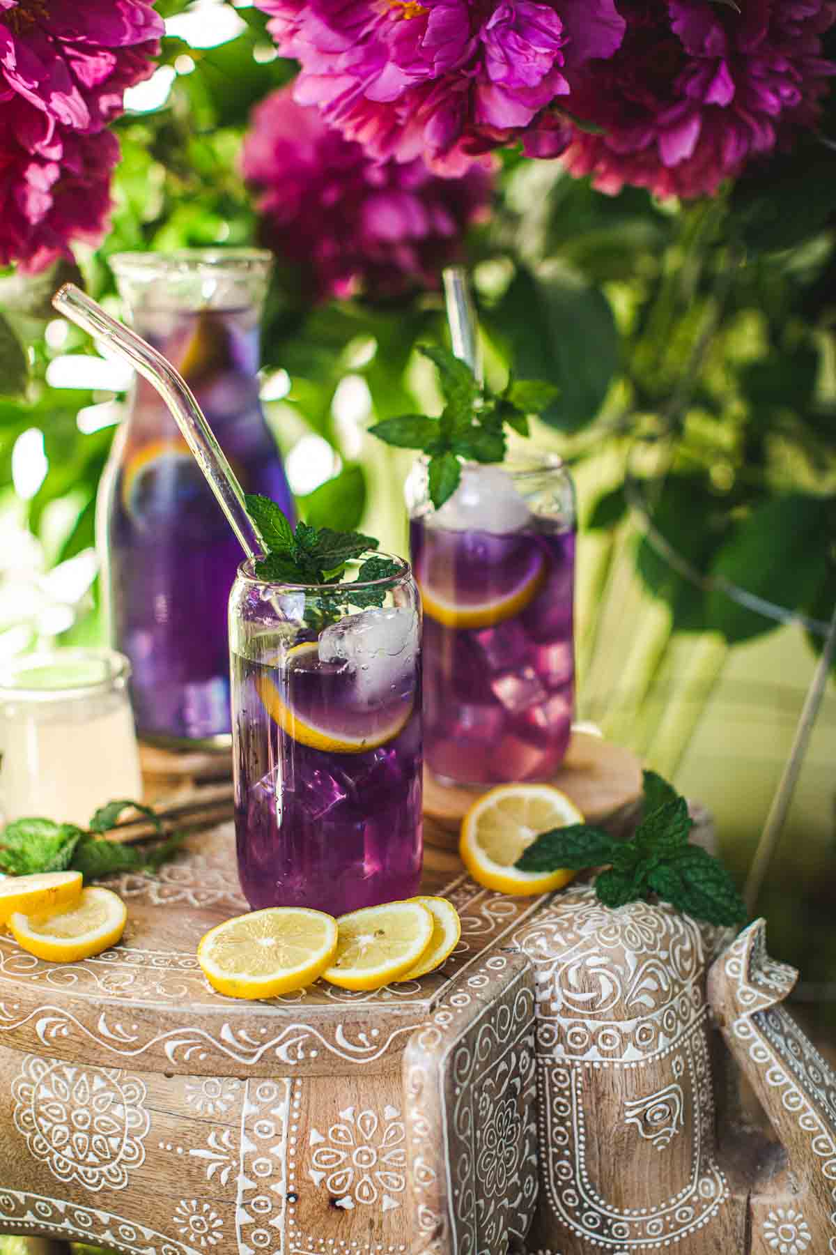 3 glasses of purple drinks on a tray