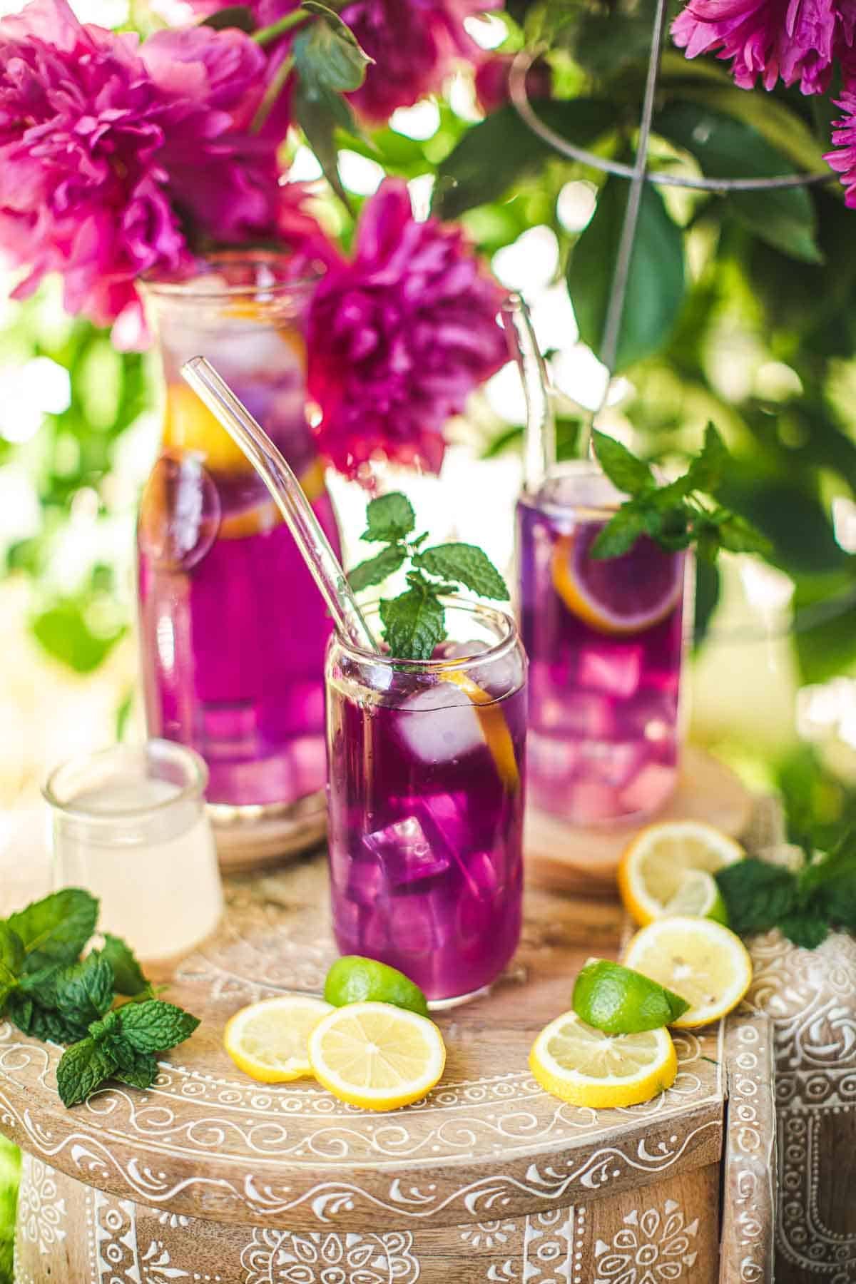 3 glasses of pink drinks on a stand