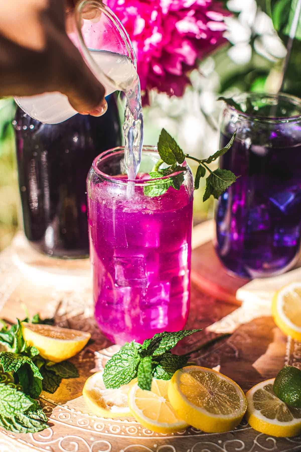 lemon juice poured over a pink drink 