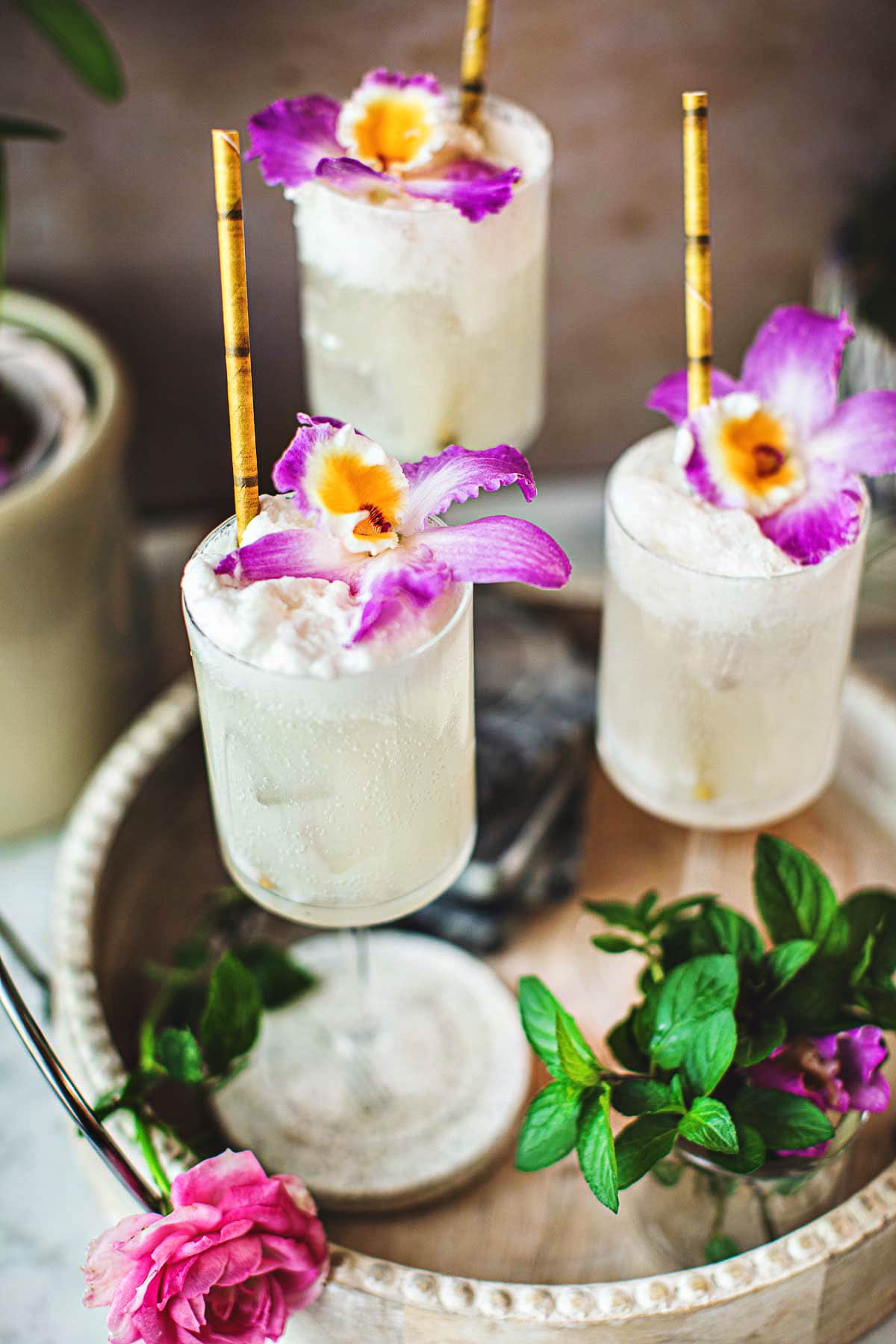 2 glasses of coconut lime mojito on a tray.