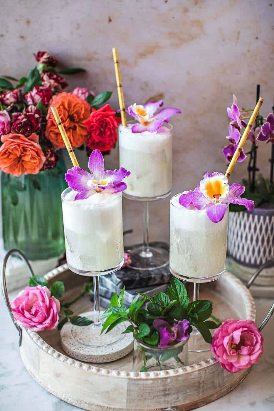 3 glasses of coconut lime mojito on a tray