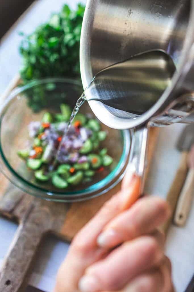 pouring liquid into a salad bowl